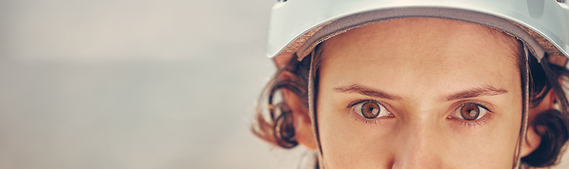 Image showing Portrait of a woman with helmet for hiking sport with a zoom in of eyes. Safety, secure and helmet for rock climbing in nature. Copy space for outdoor sports, fit and active female