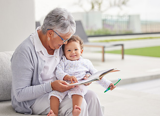 Image showing Senior woman, happy baby and children book reading of a grandmother spending quality time together. Elderly retirement of a old female about to read a fun kids story to a kid on a home patio