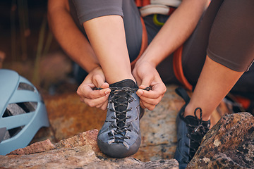 Image showing Woman tying her hiking shoes in nature preparing for a rock climbing or trekking exercise. Fitness, footwear and healthy girl doing outdoor sports activity or adventure on a mountain for wellness.