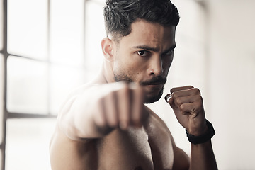 Image showing Energy, power and boxing by man fist punch in a gym or fitness studio. Portrait of athletic boxer workout or exercise, endurance and speed preparation before a kickboxing, competitive match