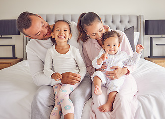 Image showing Family, bonding and bed time with children and parents smile and rest together, loving and caring in bedroom. Play, sleep and routine by young man and woman enjoy the morning with happy girl in home