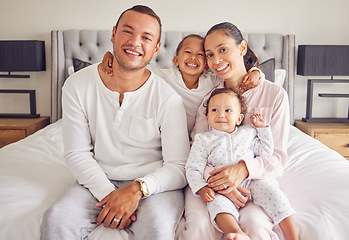 Image showing Family happy, portrait smile and relax on bed together in home, parents love for children in the morning and happiness in bedroom. Mother and father relaxing with kids and caring on the weekend