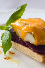 Image showing Smoked Haddock On A Bed Of Beet-root With Melted Blue Cheese