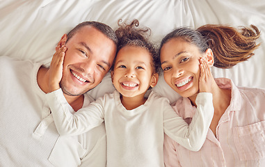 Image showing Happy, family and bed of people smile with above view in a bedroom with happiness at home. Portrait of a mother, girl and man from Spain spending quality time together with love and care at a house