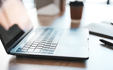 Image showing Laptop, computer and desk with a notebook on a table in an empty office at work. Technology, email and connectivity with a wireless device at a workstation for marketing, advertising or design