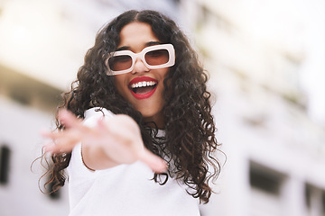 Image showing Designer sunglasses, luxury clothes and model being creative against city background, smile for summer and happy on weekend in town. Portrait of cool and trendy girl posing in fashion downtown
