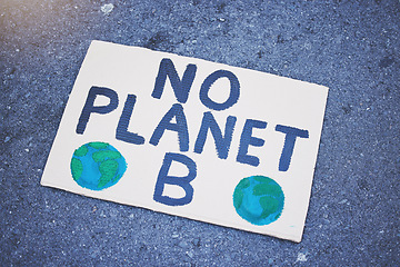 Image showing Protest poster, billboard or climate change sign on city street for planet earth, globe or world sustainability. Zoom on abstract cardboard banner in future global warming or eco environment security