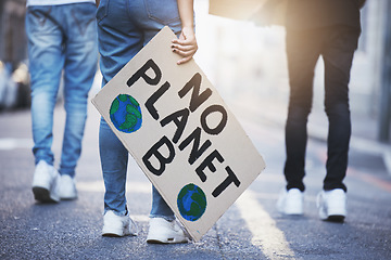 Image showing People with climate change poster or banner protest on asphalt road, street or city. Legs of group of women, walk or rally for global warming, world environment change or save the planet with flare