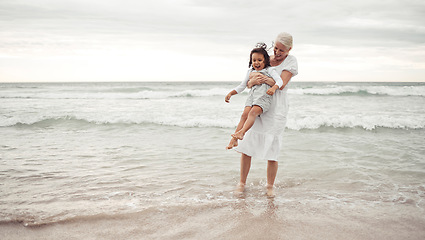 Image showing Grandmother, beach fun and child in happy bonding time together outside in nature. Elderly woman holding little girl in playful family bond at the ocean on holiday vacation in the outdoors