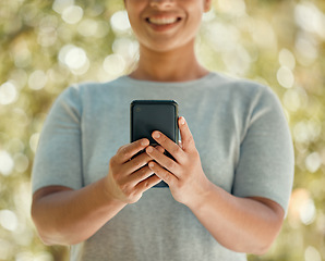 Image showing Phone, communication and woman in nature park while using a mobile app, communication tool or social media messaging outside. Closeup hands of a female with 5g network internet connection outside