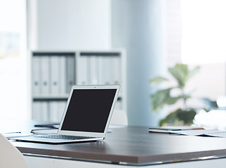 Image showing Empty office space and laptop or screen on a desk of software coding, cybersecurity and technology company or business. Creative SEO, social media and digital notebook at advertising marketing agency