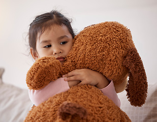 Image showing Children, fear and scary with a girl holding her teddy bear after a nightmare in her bedroom at home. Kids, anxiety and depression with a little female child hugging a stuffed animal in her house