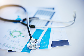 Image showing Stethoscope, paper or healthcare insurance documents in hospital, medical wellness or surgery room table. Zoom on desk, medicine equipment or data analysis research of infographic science information