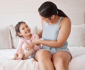 Image showing Mother with girl child on bed play, smile and laughing at comedy comic funny joke together in home bedroom. Happy woman or excited mom and young kid love smiling and enjoy playful bonding in house