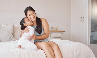 Image showing Mom on bed smile, hug happy girl in pajamas on morning in home on weekend or public holiday. Mother with child, express happiness and love in bedroom, while together on vacation or family travel