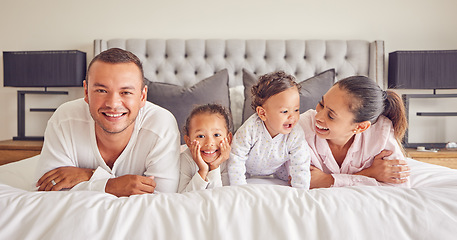 Image showing Portrait of family in home bedroom, young kids smile on bed and mother laughing with girl baby happiness. Face of happy father, morning cuddle together and funny mama relax in pyjamas on weekend rest