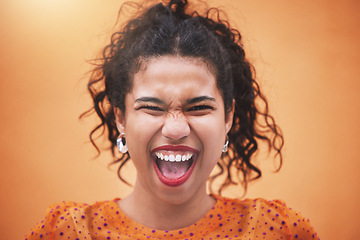 Image showing Happiness, smile and portrait of a fun woman model screaming with joy in a bright studio. Face of a happy hispanic girl with trendy, stylish and colorful clothes standing by an orange background.