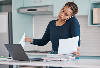 Image showing Black business woman working from home in freelance, multitasking paperwork with laptop and mobile audio phone call. Internet technology in kitchen, consulting invoice documents in covid pandemic