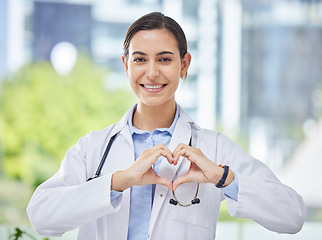 Image showing Heart, hand and icon with happy doctor in medical clinic or hospital. Happy, health and safety in the field of medicine and healthcare while love for her career, job or work while ready to help