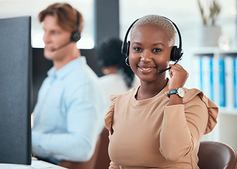 Image showing Call center woman, telemarketing and customer service consultant wearing a headset and looking happy at her office desk. Contact us and crm agent offering support and friendly service with a smile