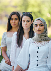 Image showing Muslim, islam and fashion with an islamic woman sitting outside with her friends in a line during the day. Religion, faith and belief with a an arab female outdoor in a row with her friendship group