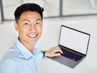 Image showing Laptop, happy and businessman taking an office selfie at work and typing an email with mockup space at desk. Smile, joy and Asian worker proud of new job sharing a picture online on social network