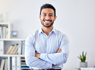 Image showing Portrait of a businessman with a smile in a corporate modern office of a startup company. Happy, career and professional manager or entrepreneur standing with his arms crossed in his workspace.