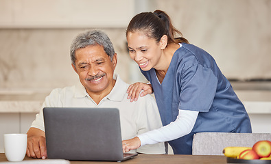 Image showing Happy nurse help senior man with laptop, showing how to make a video call or search the internet in an assisted living home. Senior patient enjoying time with healthcare worker, reading online news