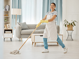 Image showing Asian cleaner woman mopping and cleaning dirt and dust in lounge or living room floor in house or home. Happy Japanese housekeeping help, hygiene maid or employee tidy and spring cleaning apartment