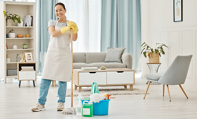 Image showing Happy woman cleaning home floor, house work and smile in home service mopping living room, job with gloves and happy to clean house apartment. Portrait of Asian cleaner or housewife housekeeping