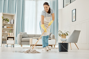 Image showing Woman cleaning the floor with a mop in the living room in home with a smile. Happy asian cleaner doing housework or job in a clean lounge, hotel room or house while smiling and alone spring cleaning