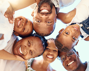 Image showing Happy black family in a huddle, face smile with mother, father, grandmother and their cute children from below. Group of people with support, trust and love together outdoor with blue sky background