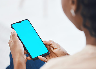 Image showing Woman on a phone with green screen networking on social media or reading online blog on website. Closeup of african hands holding smartphone while browsing on internet or mobile app while relaxing.