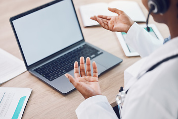 Image showing African doctor with a laptop doing an online medical consult in her office with copy space. Closeup of black healthcare worker talking on virtual medicare seminar, trade show or meeting with computer