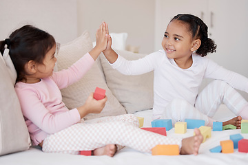 Image showing High five, children and fun playing with learning blocks and celebrating achievement or development with colorful toys at home, Adoption and interracial girls, friends or sisters bonding and support