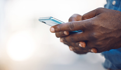 Image showing Hands of an african man on a phone networking, doing research on the internet or typing a message. Closeup of a black guy browsing on social media, mobile app or an online website with a smartphone.