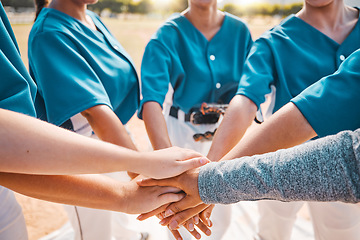 Image showing Hand, sports and teamwork with a sport team putting their hands in a huddle while standing in a circle outdoor on a field. Collaboration, goal and motivation with a group of women training for a game
