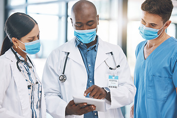 Image showing Doctor with tablet talk about data, diagnosis or strategy with team for covid management in hospital. Medic in meeting with staff, show information about virus or disease on mobile device at clinic