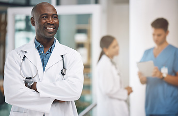 Image showing Medical, healthcare and arms crossed with doctor in hospital for vision, trust and leadership. Support, innovation and motivation with black man employee in medicine, surgery and first aid clinic