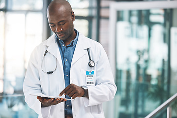 Image showing Doctor with tablet, happy reading social media post, text or email from on break at hospital. Black man in healthcare career, on internet to research information on medical science and technology