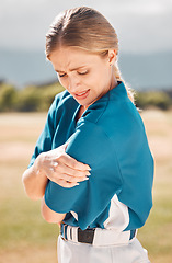 Image showing Baseball, sport and arm pain or injury on the field after an accident during the game or training. Woman sports athlete with medical emergency of muscle or joint with a sprain after match or exercise