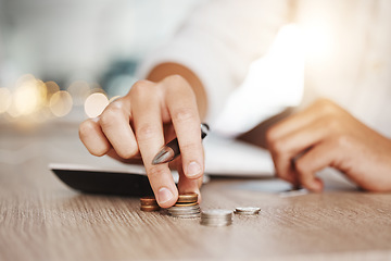 Image showing Business man hands with coins budget money for inflation, debt or finance management working with calculator on wooden table and lens flare. Entrepreneur or startup person with profit cash or savings