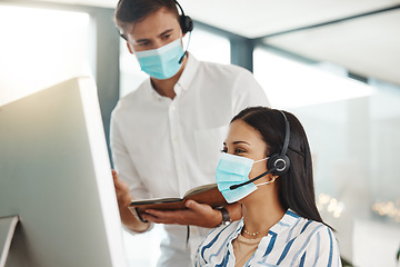 Image showing Covid, face mask and call center woman training intern on customer service computer, contact us and crm consulting office. Virus compliance, receptionist teamwork or learning consultant collaboration