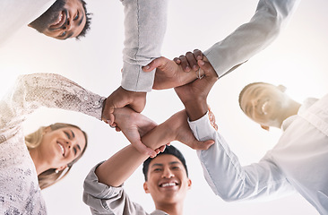 Image showing Teamwork hands, wrist and unity in collaboration, motivation and support for success, vision and goals. Below of happy, diversity and solidarity staff in partnership, cooperation and trust together