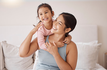 Image showing Bedroom, happy and smile of mother and girl resting and spending time together on a holiday. Relax, happiness and calm woman and her child sitting on a bed and hugging in a room of their family home.