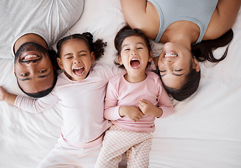 Image showing Family happy, crazy children and above bed with parents in the morning, funny face in the house and comic portrait together in home. Top view of mother and dad smile with girl kids in bedroom