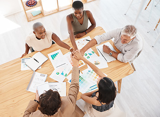 Image showing Teamwork, meeting and hands together after a branding and logo group discussion at a business office table. Motivation, diversity and collaboration for our vision, mission plan and goals top view