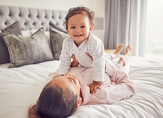 Image showing Baby, family and love with a mother and her girl bonding on bed in the bedroom of their home together. Children, parent and daughter with a single mom and her cute daughter in a house with a smile