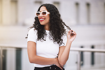 Image showing Beauty, fashion and sunglasses with woman in city outdoor for vision, cosmetics or travel. Summer, motivation and makeup with young female influencer in urban street for happy, content or lifestyle