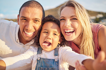 Image showing Face selfie, comic and funny happy family on a trip, vacation or holiday outdoors. Portrait, love and caring mother, father and child together at beach taking pictures spending free time bonding.